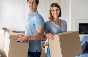 1238409 smiley couple holding boxes moving out day 1238409 smiley couple holding boxes moving out day