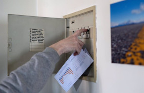 ep archivo   un hombre sube los plomos de la luz con una factura de luz en la mano en madrid espana