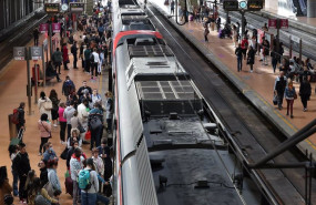 ep numerosas personas con maletas esperan en el anden la salida de un tren en la estacion almudena