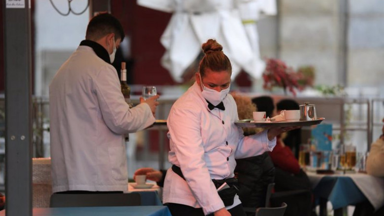 ep dos camareros trabajan en la terraza de un bar en el centro de madrid espana