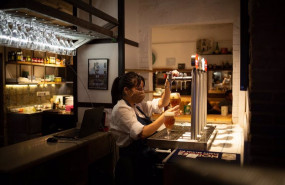 ep una camarera sirve una cerveza en el interior de un bar