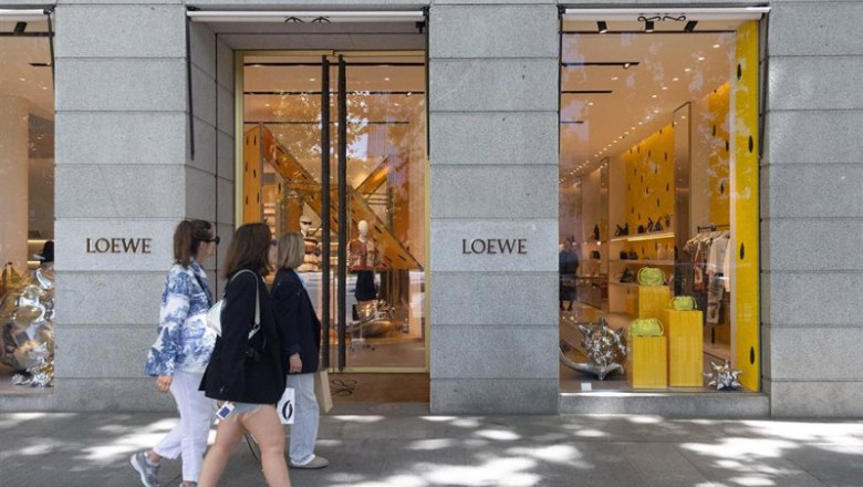 ep archivo   varias personas pasan por una tienda de loewe en la milla de oro de madrid a 3 de mayo