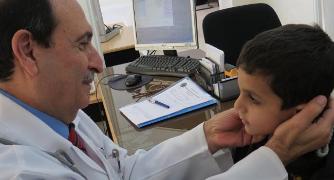Un médico atiende a un niño en su consulta | CARITAS INTERNATIONALIS ep un medico atiendeun ninosu consulta